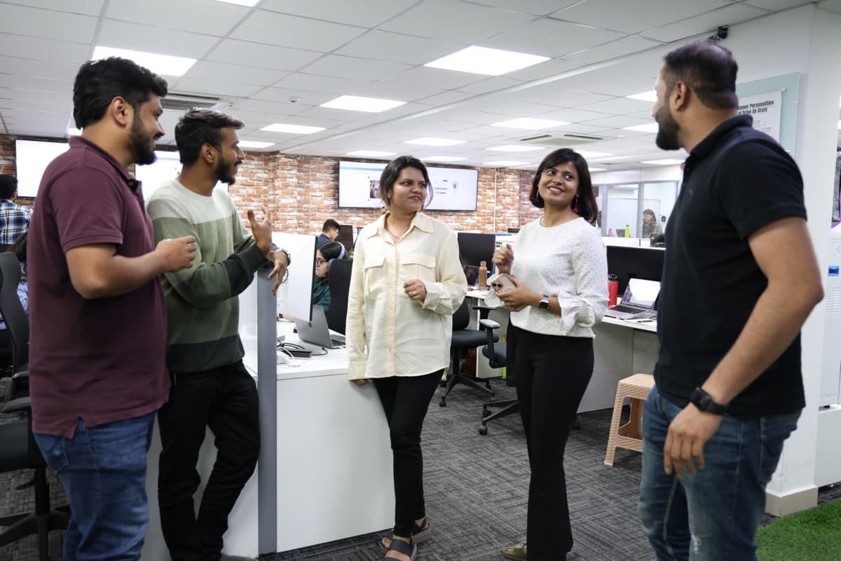 GeekyAnts engineers talking through an idea in the office