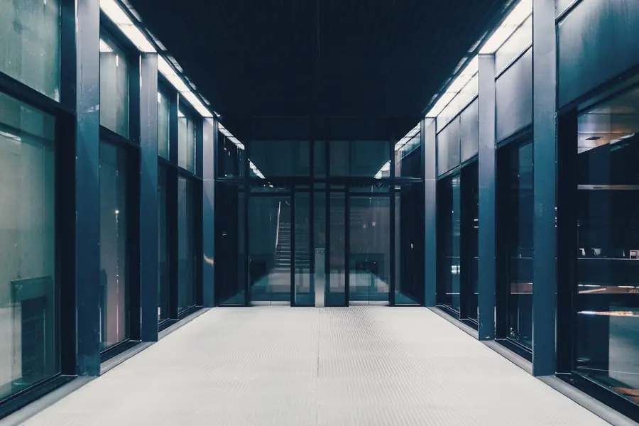 Long data centre corridor with glass doors